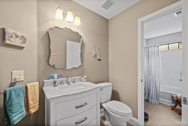 full bathroom with tile patterned floors, toilet, a textured ceiling, vanity, and shower / bath combo