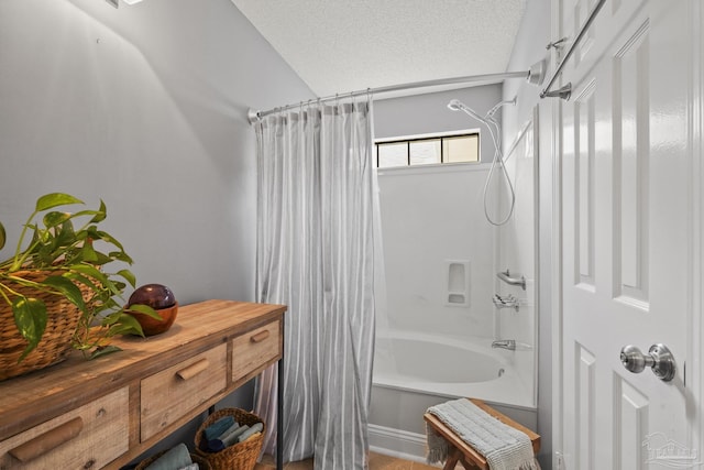 bathroom featuring shower / tub combo and a textured ceiling