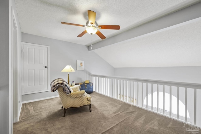 living area featuring lofted ceiling with beams, carpet, and a textured ceiling