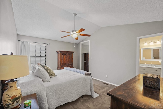 carpeted bedroom with lofted ceiling, sink, ensuite bath, a textured ceiling, and ceiling fan