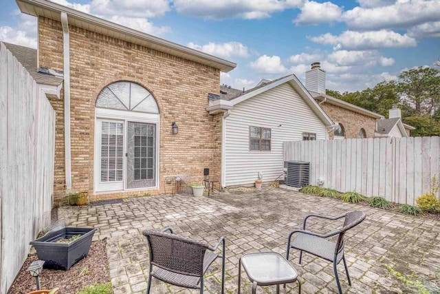 back of property with a patio area and central air condition unit