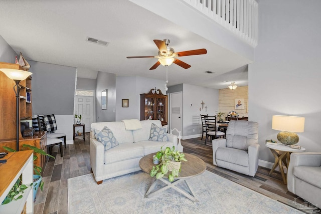 living room featuring ceiling fan and hardwood / wood-style floors