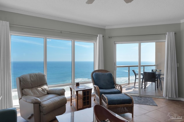 interior space with a beach view, a water view, and a healthy amount of sunlight