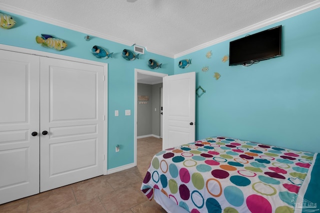 tiled bedroom with a textured ceiling, a closet, and crown molding