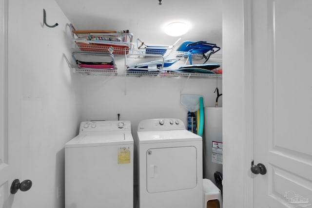 washroom with washing machine and dryer and electric water heater