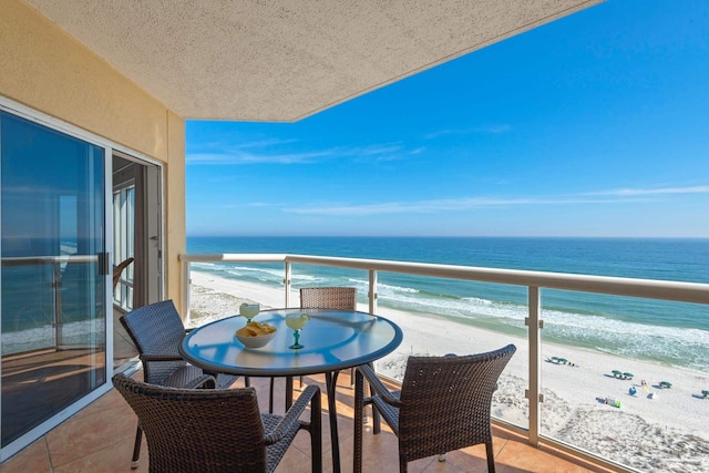 balcony with a beach view and a water view