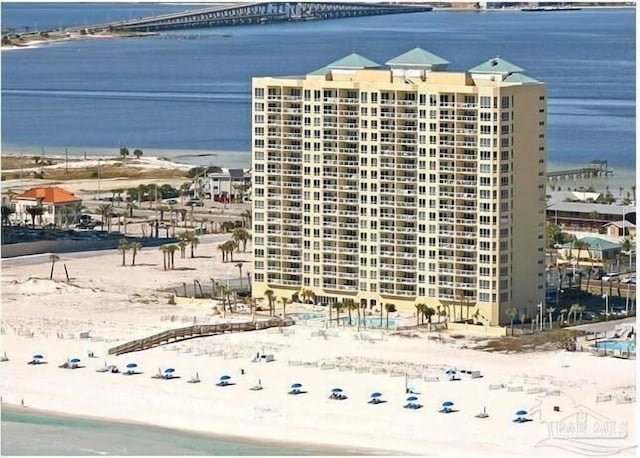 view of property featuring a water view and a beach view