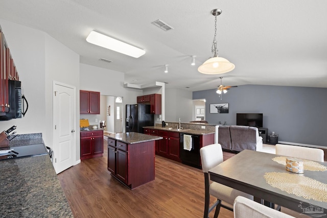 kitchen featuring a center island, sink, dark wood-type flooring, vaulted ceiling, and black appliances