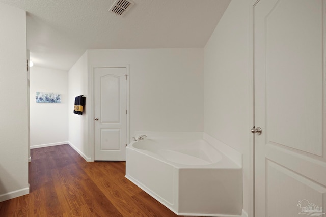 hallway featuring a textured ceiling and dark wood-type flooring