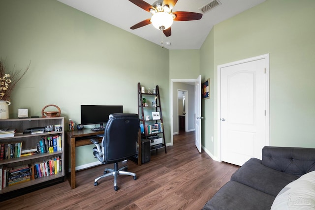 home office with lofted ceiling, ceiling fan, and dark wood-type flooring