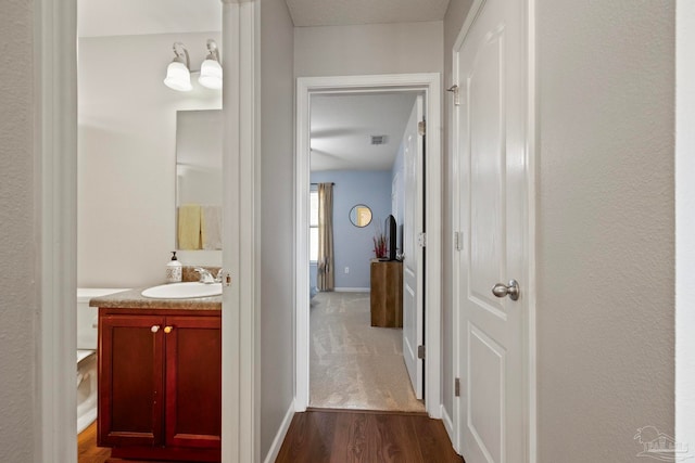 hallway featuring dark hardwood / wood-style floors and sink