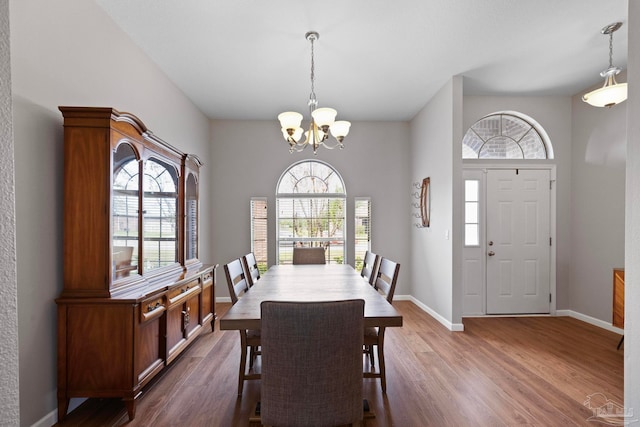 dining room featuring a chandelier and dark wood-type flooring