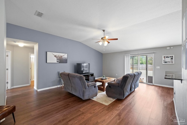 living room featuring dark hardwood / wood-style floors, vaulted ceiling, and ceiling fan