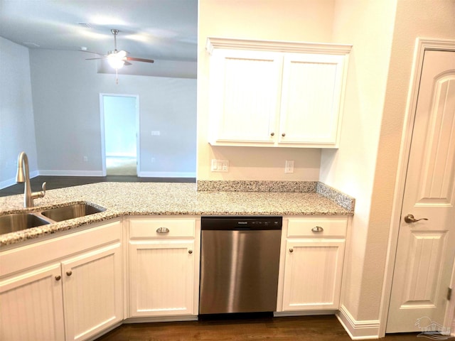 kitchen with ceiling fan, light stone counters, dark wood-style flooring, stainless steel dishwasher, and a sink