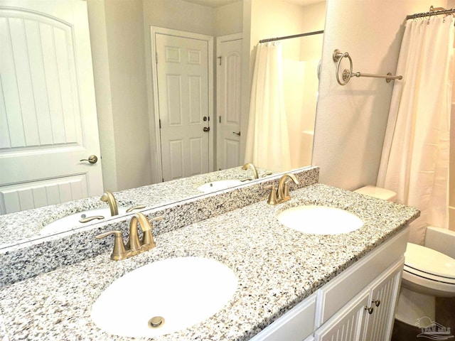 bathroom featuring shower / bath combination with curtain, a sink, and toilet