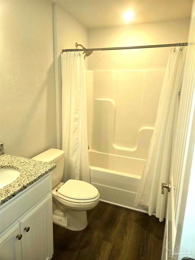 full bathroom with toilet, vanity, wood finished floors, and shower / bath combo with shower curtain