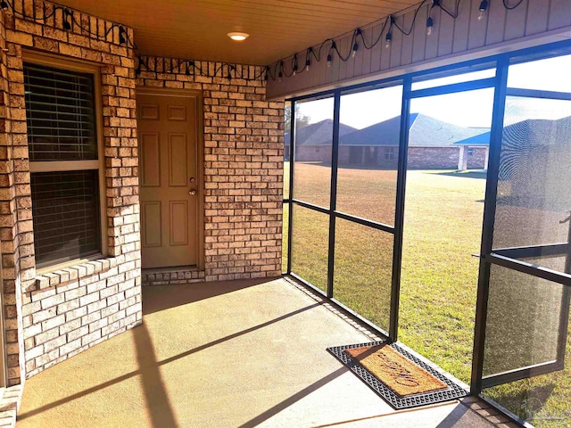 unfurnished sunroom with a mountain view