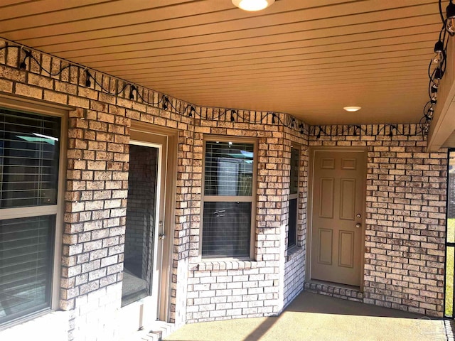 property entrance with brick siding