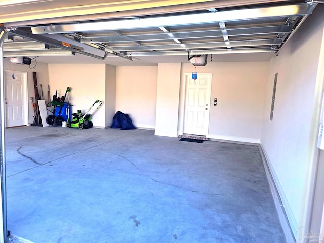 garage featuring baseboards and a garage door opener