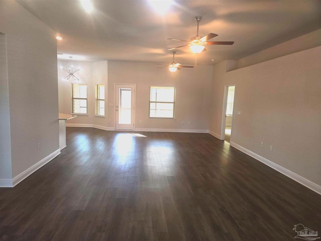 empty room with baseboards, dark wood finished floors, and a ceiling fan