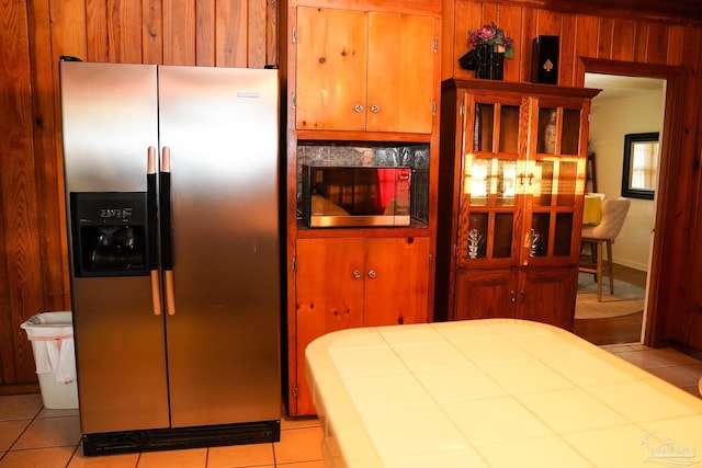 tiled bedroom with wooden walls and stainless steel fridge