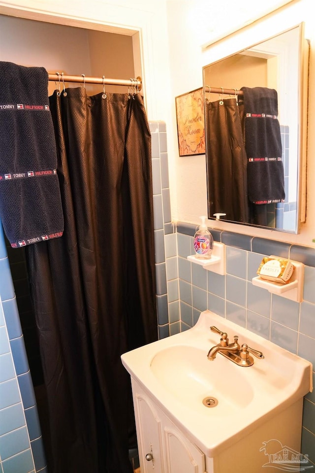 bathroom featuring tile walls and vanity