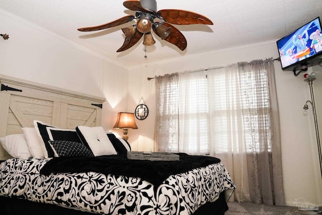 bedroom with ornamental molding, carpet flooring, and ceiling fan