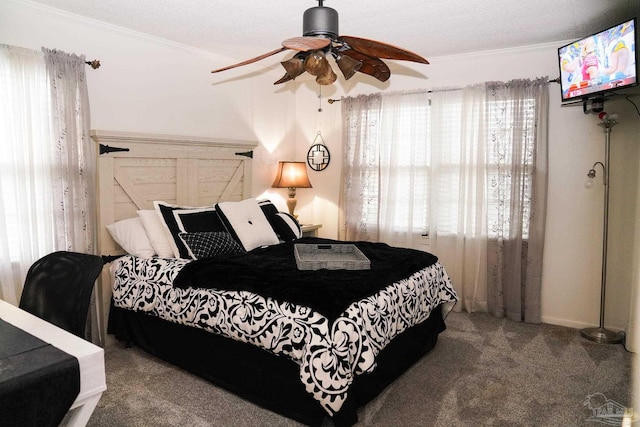 carpeted bedroom with ornamental molding, a textured ceiling, and ceiling fan