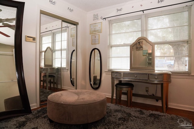 sitting room with a wealth of natural light, ornamental molding, and dark hardwood / wood-style flooring