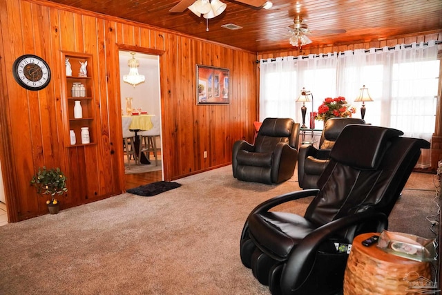 living room with wood ceiling, carpet floors, wooden walls, and ceiling fan