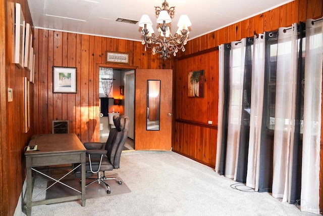 carpeted office space featuring a notable chandelier and wooden walls