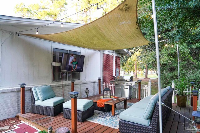 wooden terrace with grilling area and an outdoor hangout area