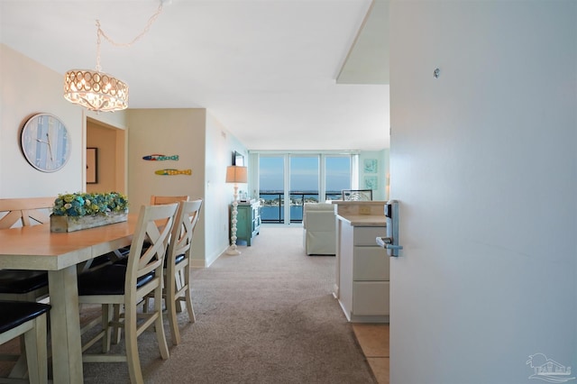 330FORT Pickens Rd Unit 11C, Pensacola Beach, FL 32561 - dining space with expansive windows, light carpet, baseboards, and a notable chandelier
