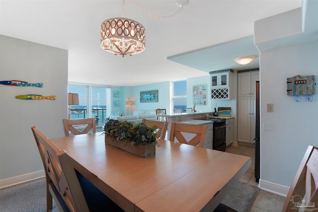 330FORT Pickens Rd Unit 11C, Pensacola Beach, FL 32561 - dining space with a chandelier, bar area, baseboards, and light tile patterned floors