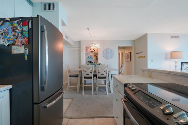 330FORT Pickens Rd Unit 11C, Pensacola Beach, FL 32561 - kitchen with visible vents, appliances with stainless steel finishes, light countertops, and light colored carpet