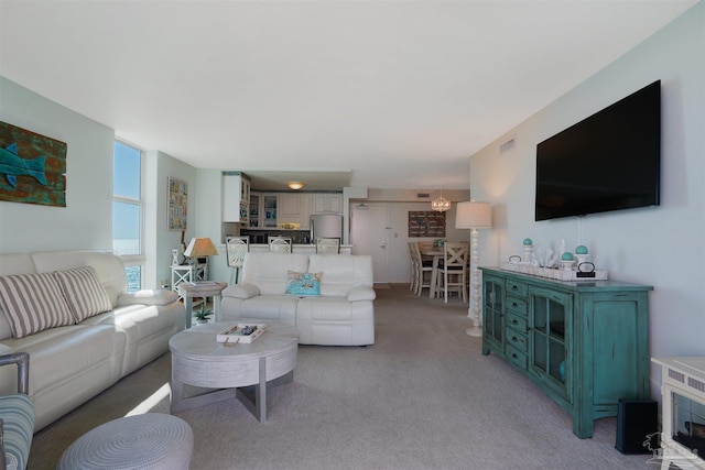 330FORT Pickens Rd Unit 11C, Pensacola Beach, FL 32561 - living room featuring light carpet, an inviting chandelier, and visible vents