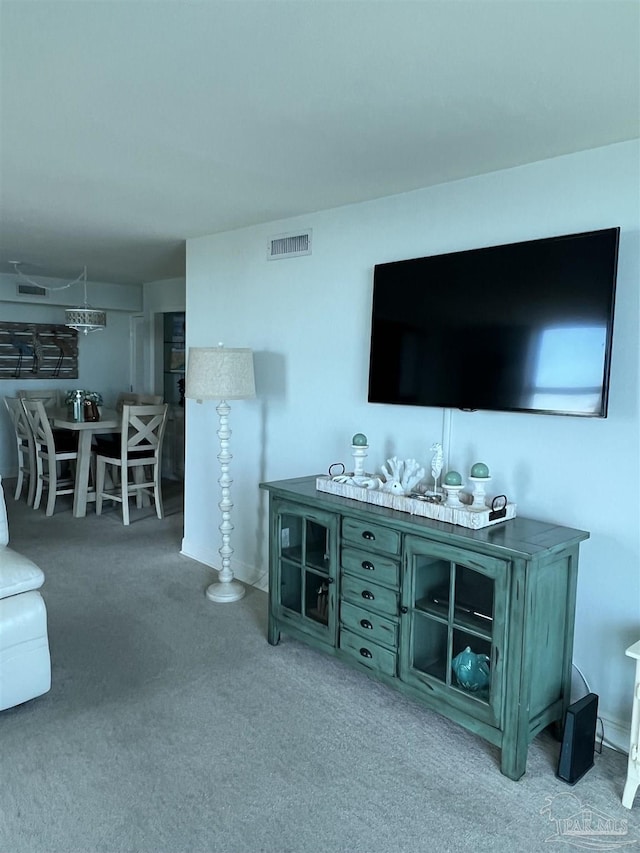 living room featuring visible vents and carpet flooring