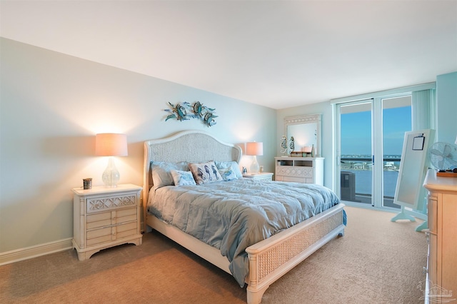 330FORT Pickens Rd Unit 11C, Pensacola Beach, FL 32561 - carpeted bedroom featuring access to exterior, expansive windows, and baseboards