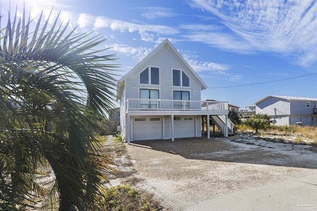 view of front of home featuring a balcony and a garage