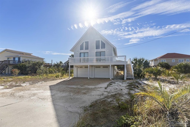 raised beach house with a balcony and a garage