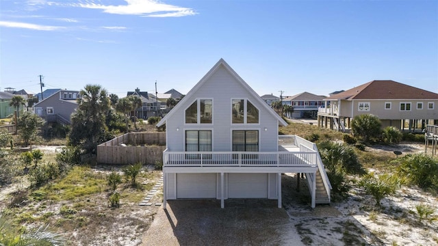 back of house featuring a balcony and a garage