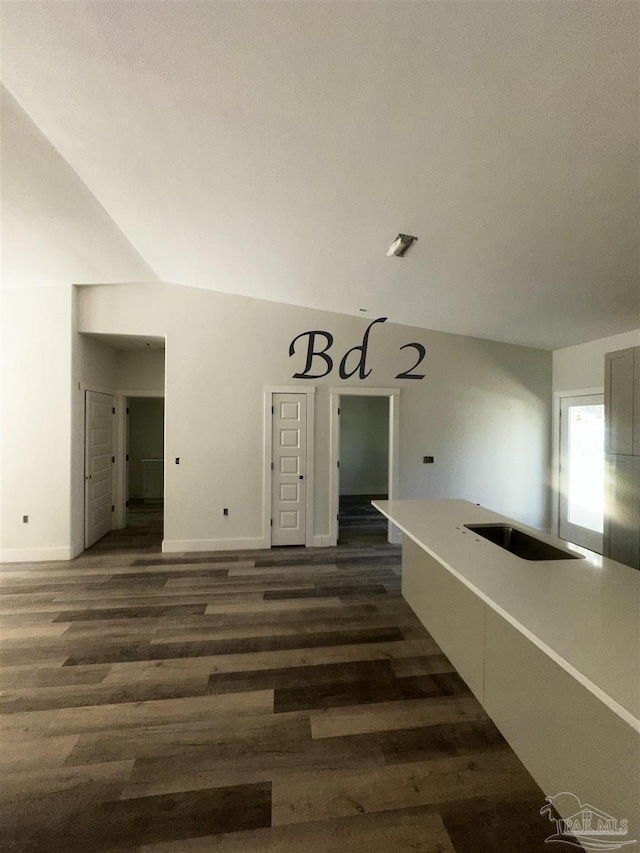 interior space with dark wood-type flooring and baseboards