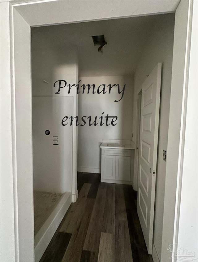 mudroom with baseboards and dark wood-type flooring