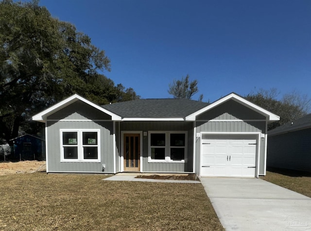 ranch-style house featuring a garage, roof with shingles, concrete driveway, and a front yard