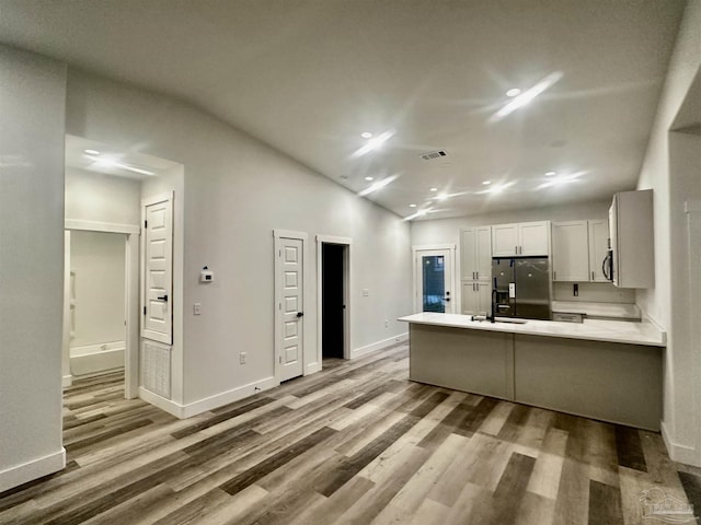 2020 Talbert St, Pensacola, FL 32507 - kitchen featuring black fridge with ice dispenser, a peninsula, wood finished floors, light countertops, and recessed lighting