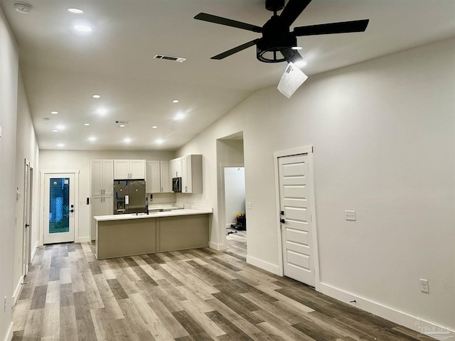 2020 Talbert St, Pensacola, FL 32507 - kitchen featuring fridge with ice dispenser, a ceiling fan, a peninsula, light wood finished floors, and light countertops