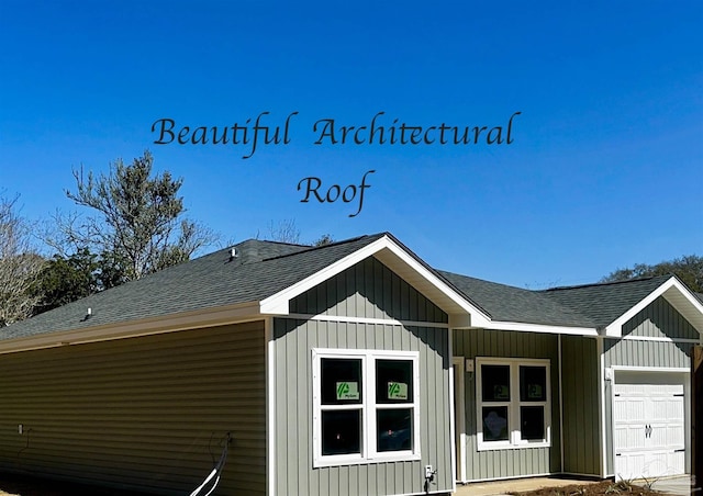 view of front of property with board and batten siding, roof with shingles, and an attached garage