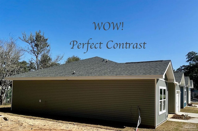 view of side of property with a shingled roof