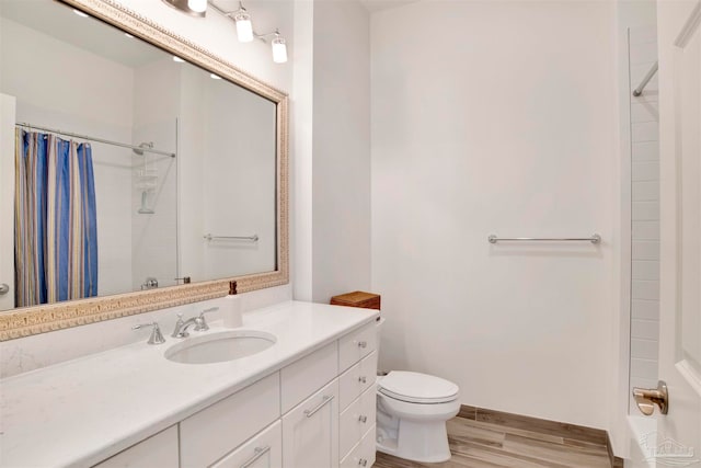 bathroom with walk in shower, vanity, toilet, and wood-type flooring