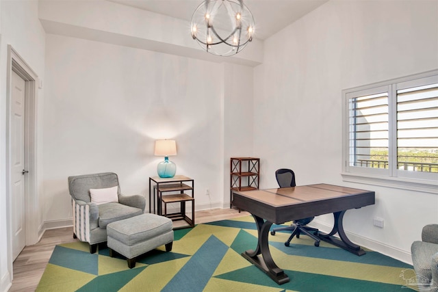 office area featuring an inviting chandelier and light hardwood / wood-style floors